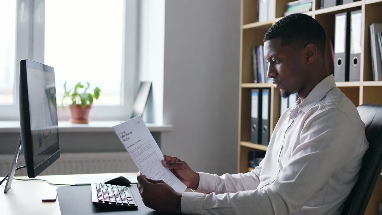 A professional reviewing a document at a desk