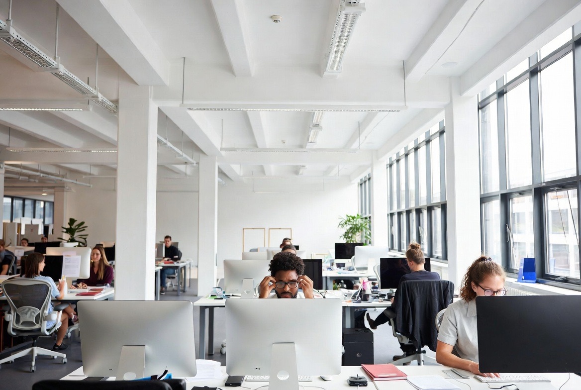 A team collaborating over laptops in a modern office